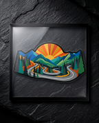 A framed art print featuring a colorful vector illustration of a winding road through green pine forests and blue mountains under a yellow and orange sun, displayed on a dark textured slate background.