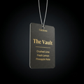 Black air freshener tag with gold text on a black background