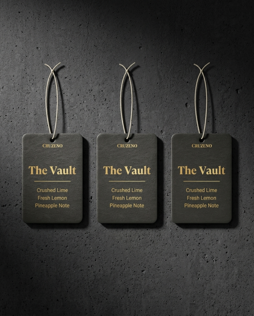 Three 'The Vault' fragrance tags on a dark textured background