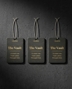 Three 'The Vault' fragrance tags on a dark textured background