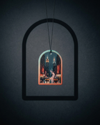 An arched pendant necklace featuring a miniature window view of a New York City street scene with illuminated skyscrapers and traffic, suspended against a dark textured background.
