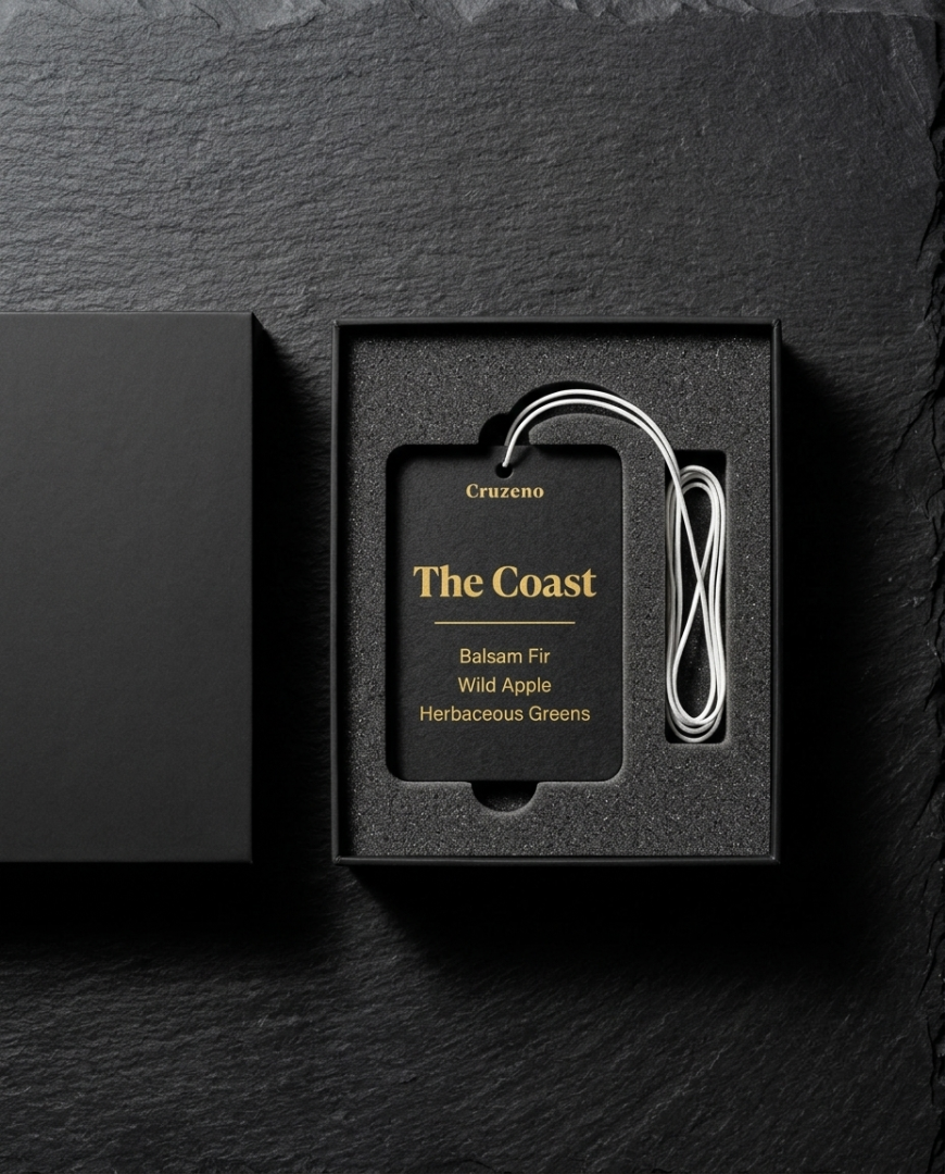 Black packaging with a label and white cable on a dark stone background