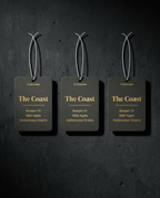 Three Cruzero 'The Coast' air freshener tags on a dark background