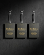 Three 'The Ember' product tags hanging against a dark textured background
