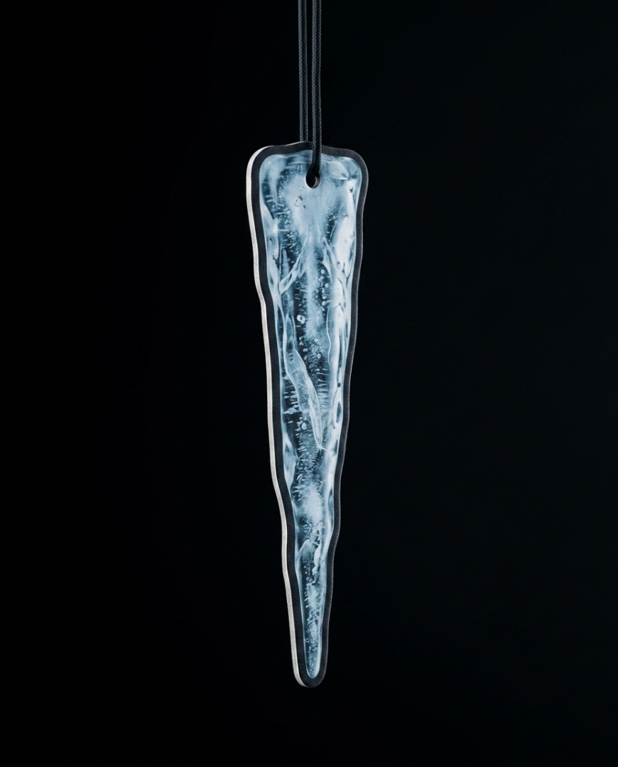 An elongated, tapered glass ornament with a textured, icy blue and white pattern inside a clear glass body, suspended by a black cord against a solid black background.