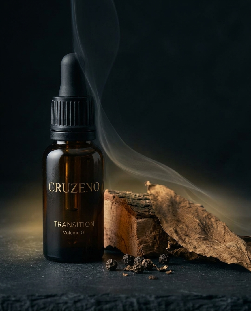 A dark amber glass dropper bottle labeled CRUZENO TRANSITION Volume 87, styled on a dark surface with a dried leaf, wood piece, and scattered seeds under moody lighting with smoke.